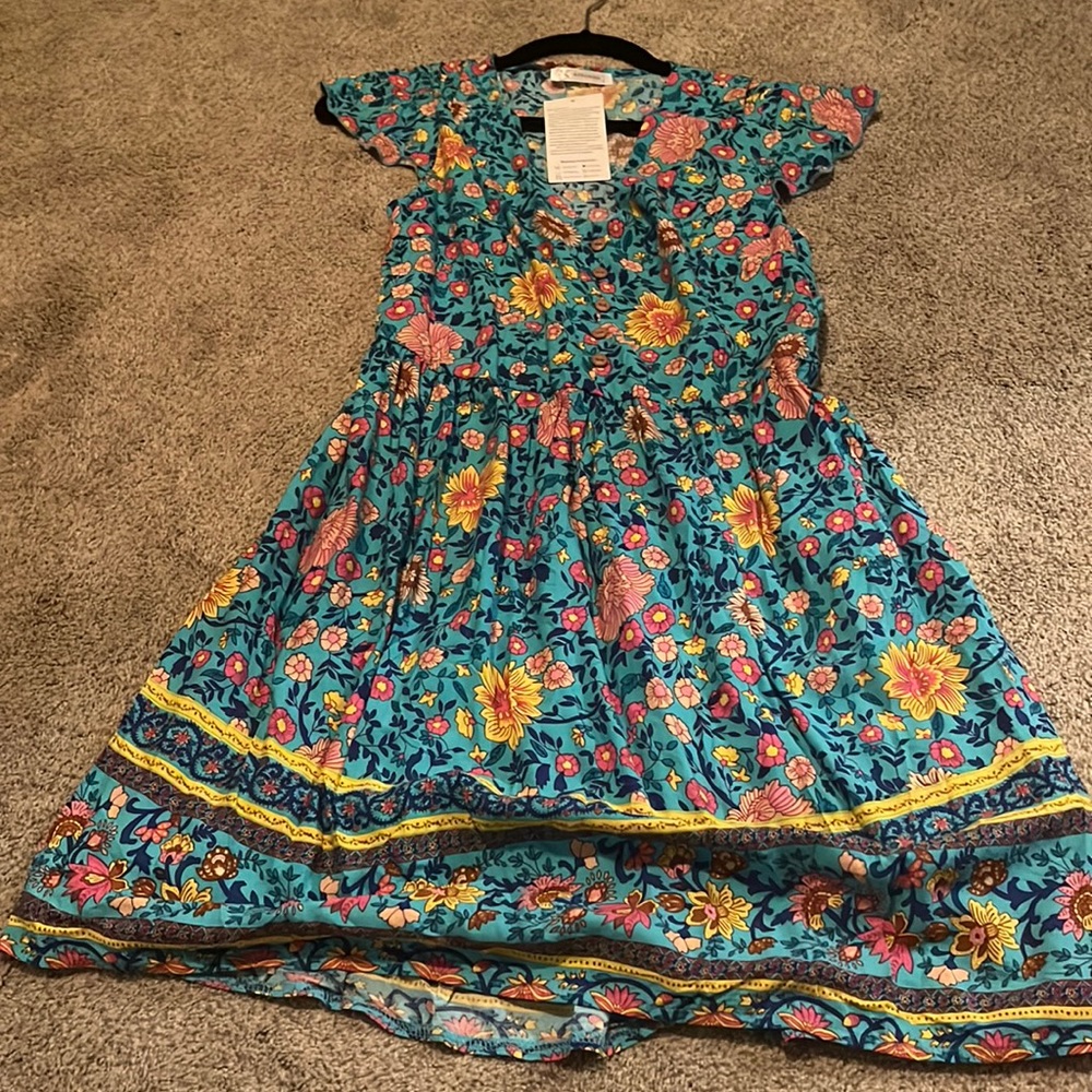 Blue patterned sundress with flowers on it.